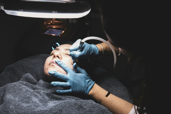 person fixing someone's face